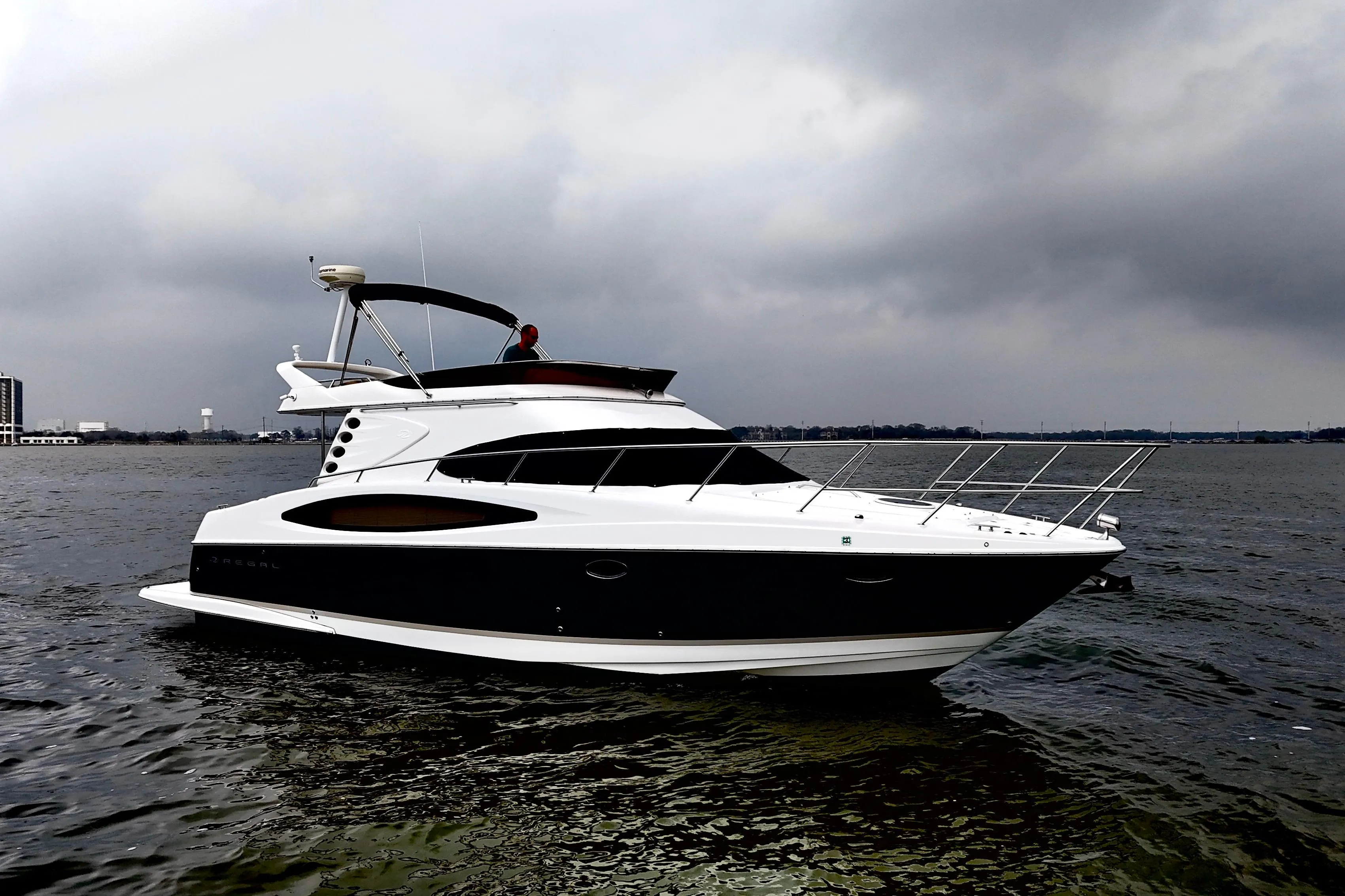 2007 Regal 4080 Flybridge Sedan on calm water under cloudy skies.