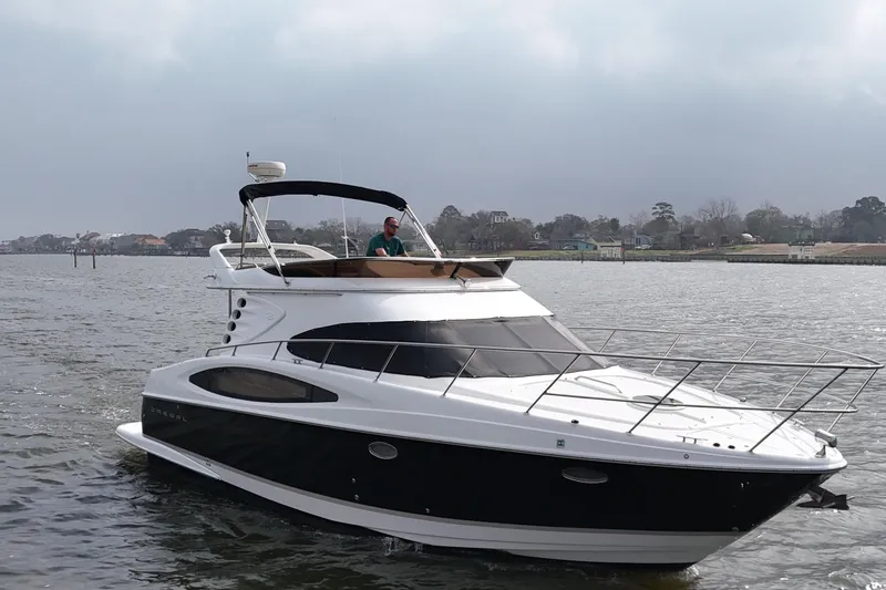 Barbie Hunter Yacht Photos Pics 2007 Regal 4080 Flybridge Sedan on calm waters.