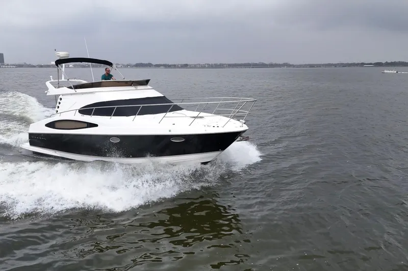 Barbie Hunter Yacht Photos Pics 2007 Regal 4080 Flybridge Sedan cruising on open water.