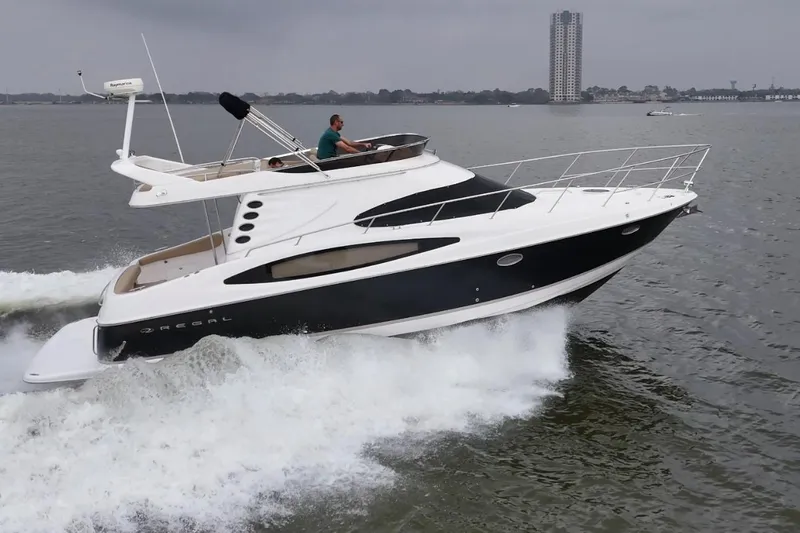 Barbie Hunter Yacht Photos Pics 2007 Regal 4080 Flybridge Sedan cruising on water.