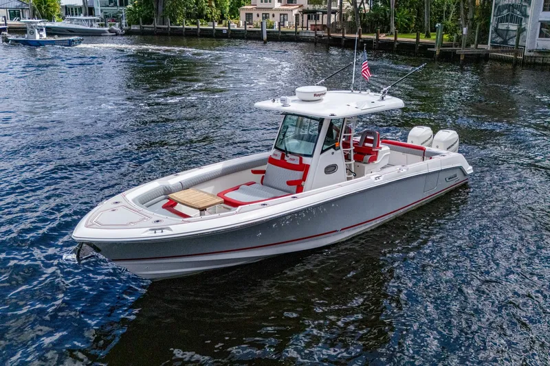 Dare To Dream's Sidechick Yacht Photos Pics 2018 Boston Whaler 330 boat on water, featuring sleek design and modern amenities.