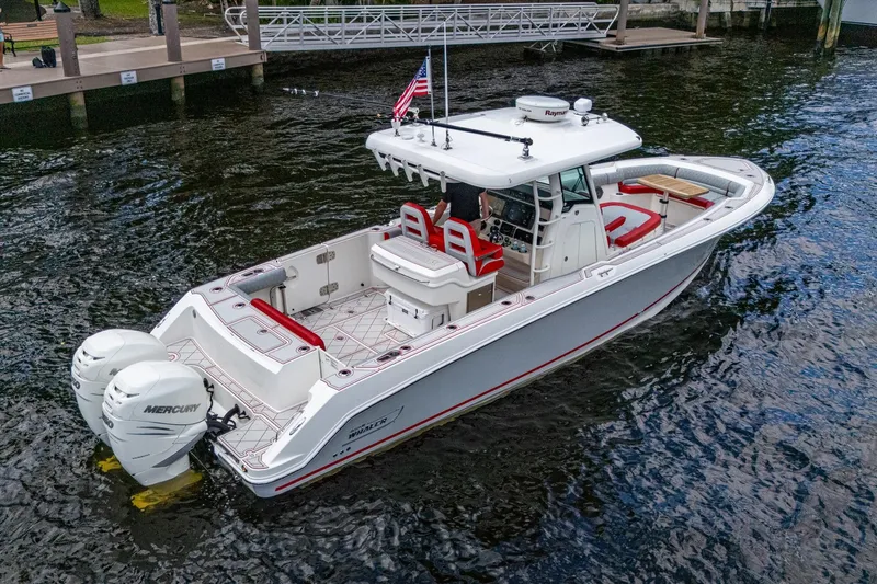 Dare To Dream's Sidechick Yacht Photos Pics 2018 Boston Whaler 330 boat with dual Mercury engines on a calm waterway.