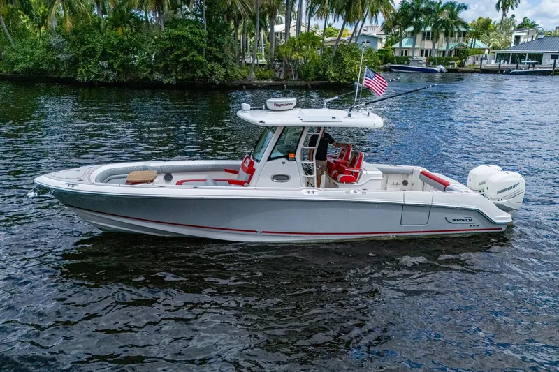 Dare To Dream's Sidechick Yacht Photos Pics 2018 Boston Whaler 330 boat on water, featuring sleek design and American flag.