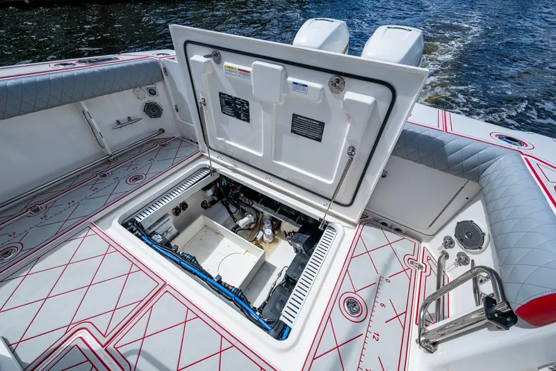 Dare To Dream's Sidechick Yacht Photos Pics 2018 Boston Whaler 330 boat with open hatch, revealing interior components and wiring.