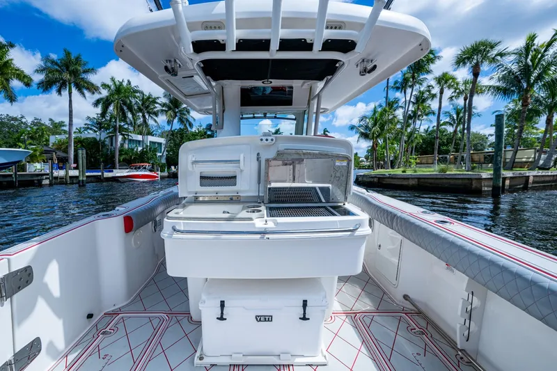 Dare To Dream's Sidechick Yacht Photos Pics 2018 Boston Whaler 330 boat interior with fishing station and tropical waterfront view.