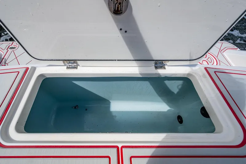 Dare To Dream's Sidechick Yacht Photos Pics Open storage compartment on a 2018 Boston Whaler 330 boat, featuring a clean interior.