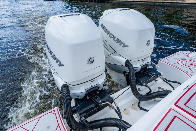 Dare To Dream's Sidechick Yacht Photos Pics Twin Mercury outboard engines on a 2018 Boston Whaler 330 boat in water.