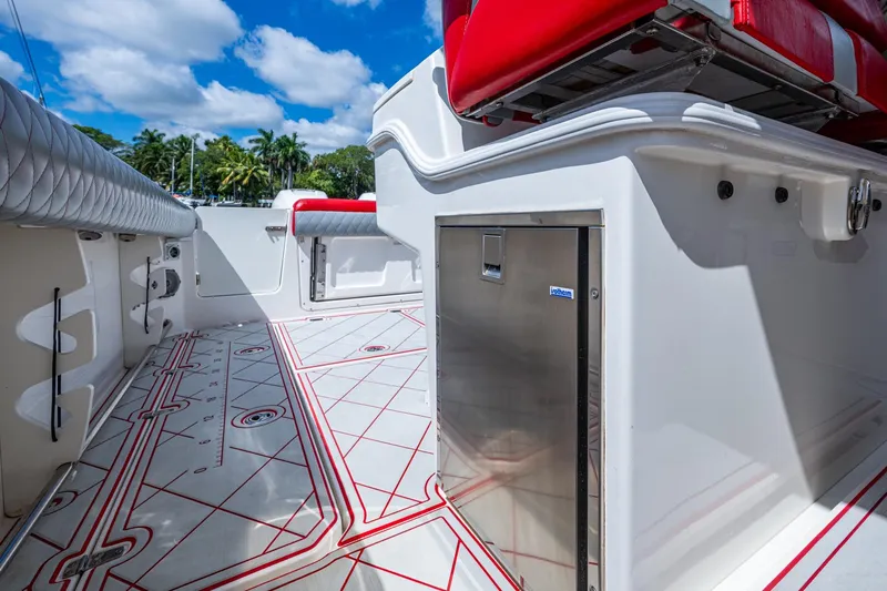 Dare To Dream's Sidechick Yacht Photos Pics 2018 Boston Whaler 330 boat interior with red seating and stainless steel storage.