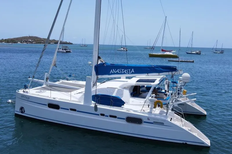  Yacht Photos Pics Catana 522 Ocean Class 2003 catamaran "Anastasia" anchored in a serene bay.