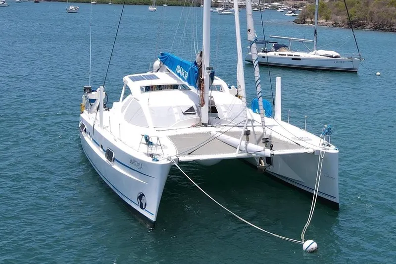  Yacht Photos Pics 2003 Catana 522 Ocean Class catamaran anchored in a scenic bay.