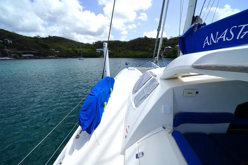  Yacht Photos Pics Catana 522 Ocean Class 2003 sailboat on calm waters, scenic coastal backdrop.