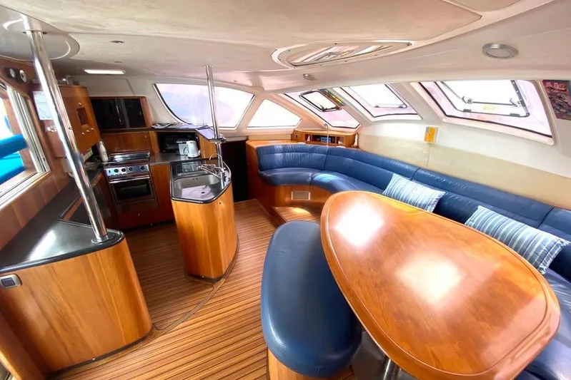  Yacht Photos Pics Luxurious interior of 2003 Catana 522 Ocean Class yacht with modern kitchen and seating area.
