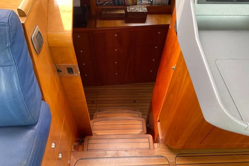  Yacht Photos Pics Interior of 2003 Catana 522 Ocean Class yacht with wooden stairs and blue seating.