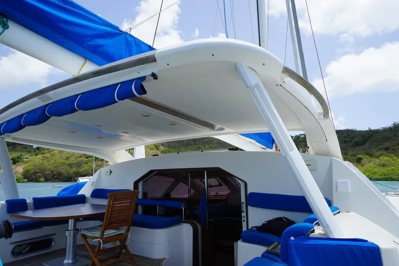  Yacht Photos Pics Catana 522 Ocean Class 2003 catamaran with blue accents, docked in a scenic bay.