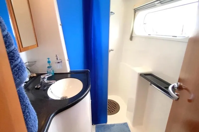  Yacht Photos Pics Bathroom interior of 2003 Catana 522 Ocean Class yacht with sink and shower.