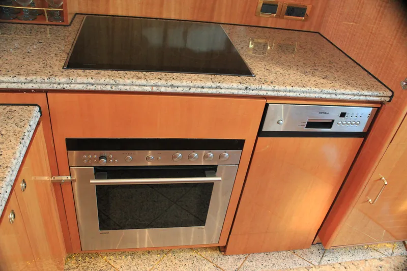 Osprey Yacht Photos Pics Modern kitchen with granite countertops, built-in oven, and stovetop on Horizon P70 yacht.