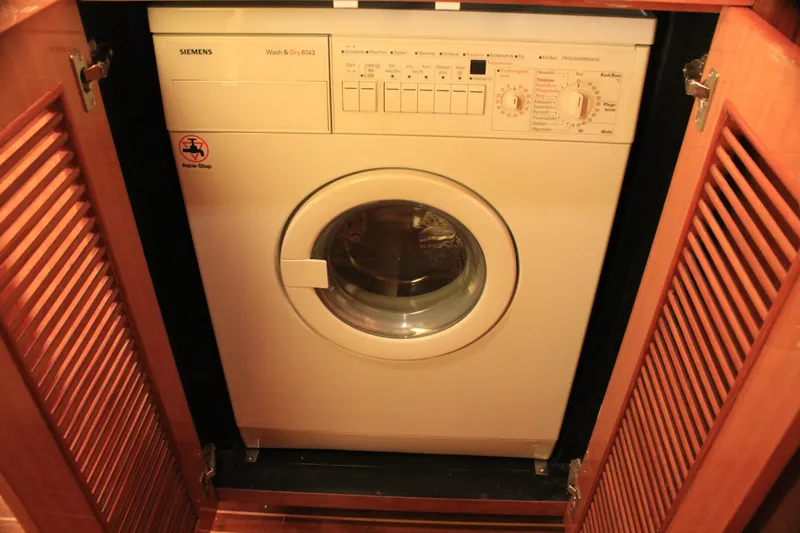 Osprey Yacht Photos Pics Washing machine in wooden cabinet on Horizon P70 yacht, 2004 model.