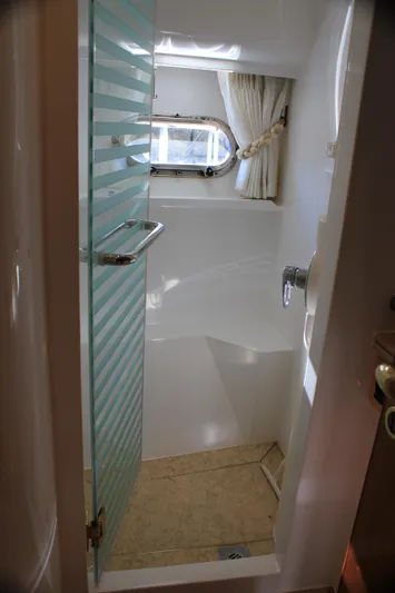 Osprey Yacht Photos Pics Compact bathroom with glass door in 2004 Horizon P70 yacht.