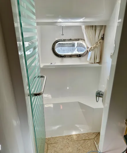 Osprey Yacht Photos Pics Luxurious bathroom in 2004 Horizon P70 yacht with glass door and porthole window.
