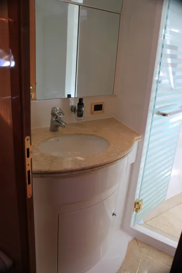 Osprey Yacht Photos Pics Luxurious bathroom in 2004 Horizon P70 yacht with marble countertop and glass shower.