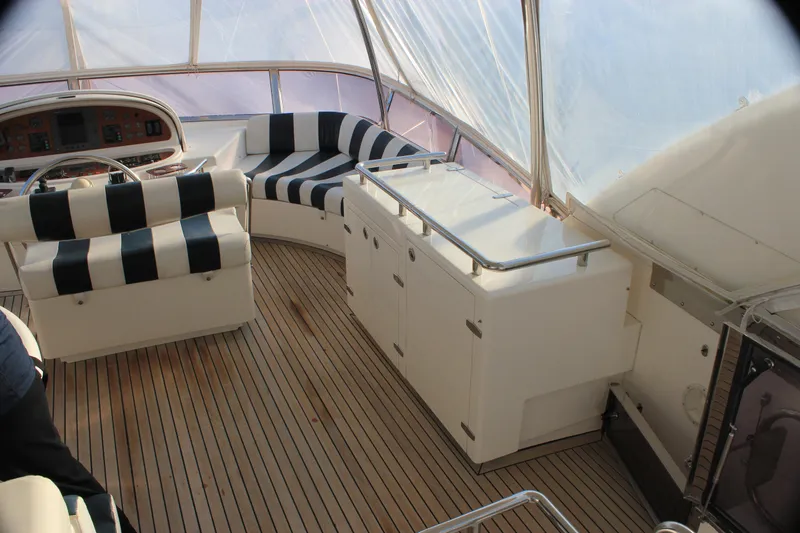 Osprey Yacht Photos Pics Luxurious 2004 Horizon P70 yacht interior with striped seating and wooden flooring.