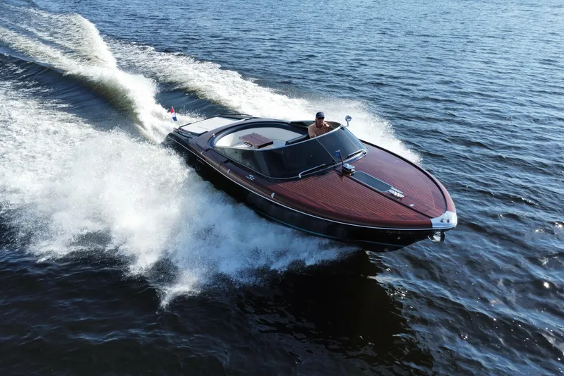  Yacht Photos Pics 2025 Riva Aquariva Special speedboat cruising on open water, showcasing sleek design and powerful performance.