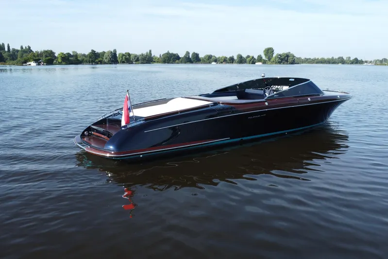  Yacht Photos Pics 2025 Riva Aquariva Special luxury boat on calm lake waters.