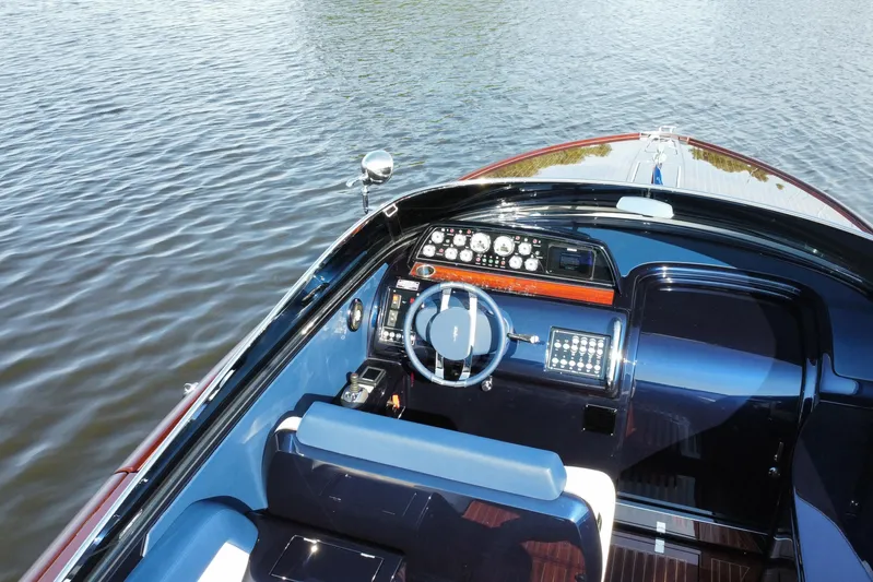  Yacht Photos Pics 2025 Riva Aquariva Special boat cockpit with sleek design on calm water.
