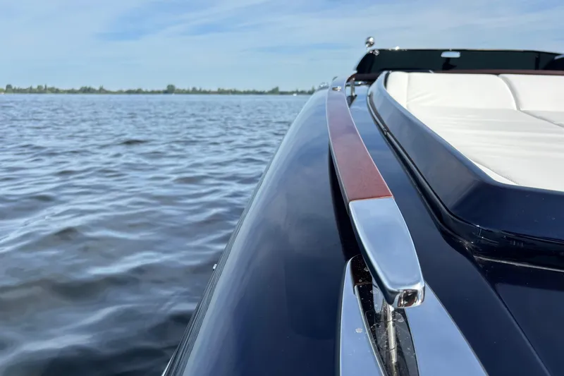  Yacht Photos Pics 2025 Riva Aquariva Special luxury boat on calm water, showcasing sleek design and elegance.