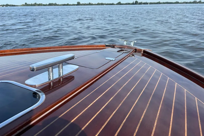  Yacht Photos Pics 2025 Riva Aquariva Special boat with polished wooden deck on calm water.