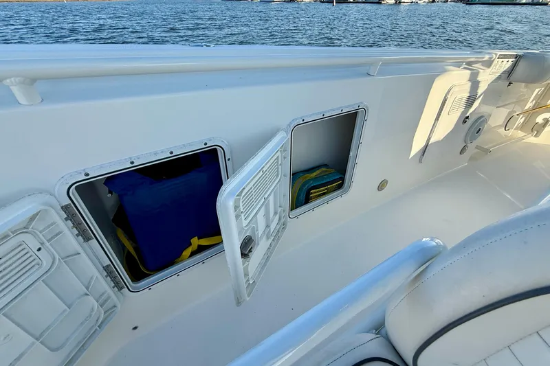 Salt Shaker Yacht Photos Pics 2008 Everglades 350 Center Console boat with open storage compartments by the water.