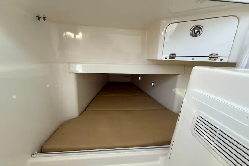 Salt Shaker Yacht Photos Pics 2008 Everglades 350 Center Console cabin interior with storage and cushioned seating.