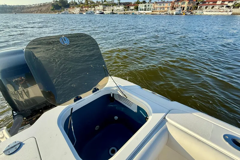 Salt Shaker Yacht Photos Pics 2008 Everglades 350 Center Console boat on water, open storage compartment, scenic waterfront view.
