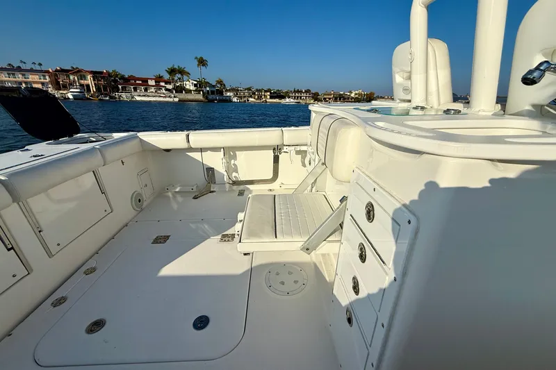 Salt Shaker Yacht Photos Pics 2008 Everglades 350 Center Console boat interior with seating and storage, docked near waterfront homes.