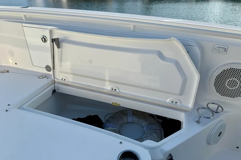 Salt Shaker Yacht Photos Pics 2008 Everglades 350 Center Console boat storage compartment with open hatch and life preserver.