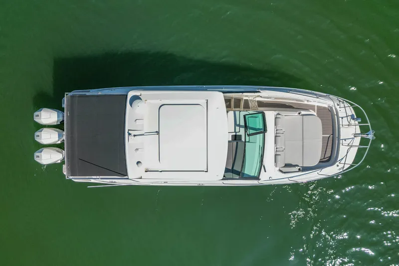 Sail Pending Yacht Photos Pics Top view of 2022 Sea Ray Sundancer 320 Outboard on green water.