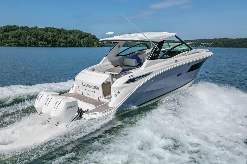 Sail Pending Yacht Photos Pics 2022 Sea Ray Sundancer 320 Outboard cruising on a serene lake with lush greenery.