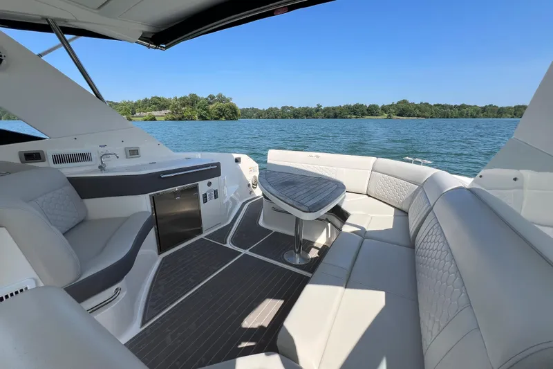 Sail Pending Yacht Photos Pics Luxurious 2022 Sea Ray Sundancer 320 Outboard interior with plush seating and scenic water view.