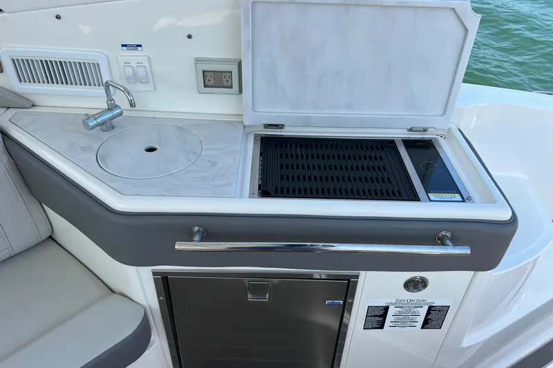 Sail Pending Yacht Photos Pics 2022 Sea Ray Sundancer 320 Outboard boat kitchenette with sink and grill.