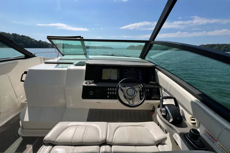 Sail Pending Yacht Photos Pics 2022 Sea Ray Sundancer 320 Outboard helm with modern controls, cruising on a sunny lake.