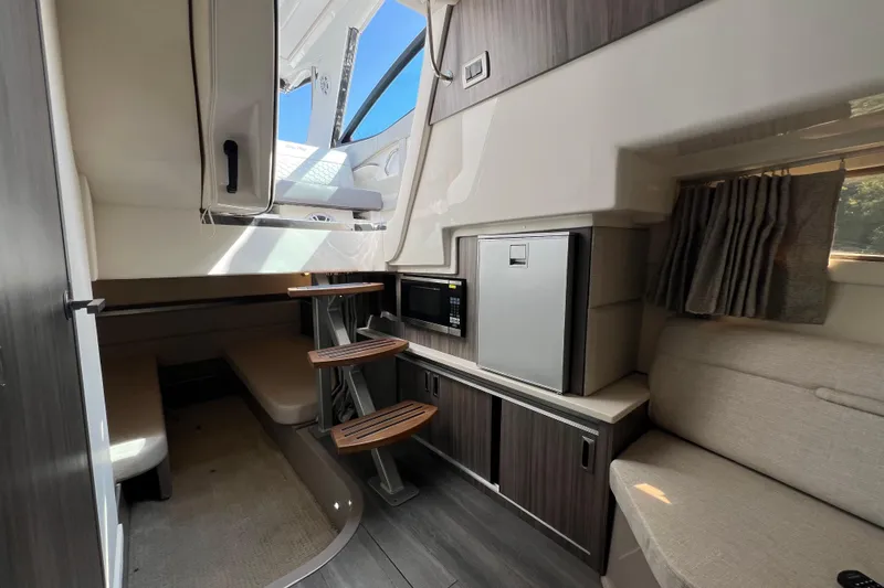 Sail Pending Yacht Photos Pics Interior of 2022 Sea Ray Sundancer 320 Outboard, featuring modern kitchenette and seating area.