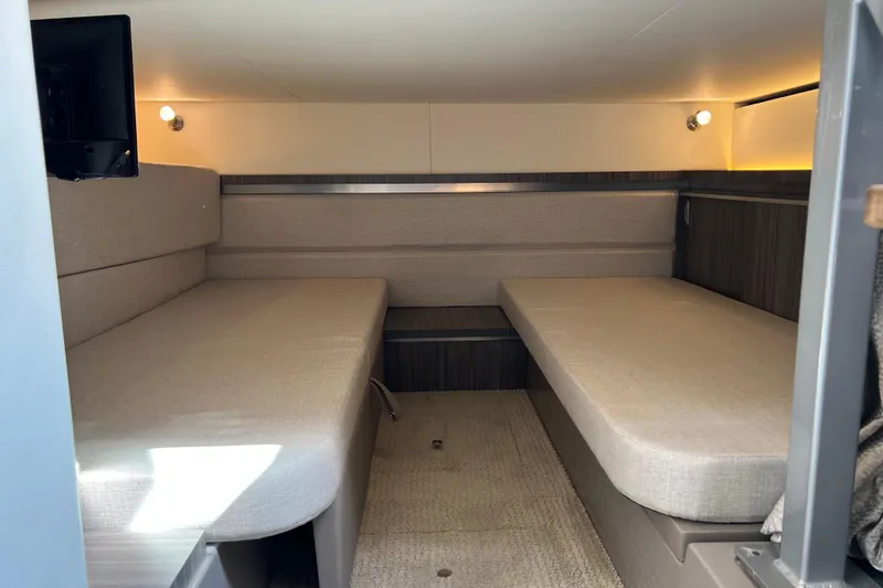 Sail Pending Yacht Photos Pics 2022 Sea Ray Sundancer 320 Outboard cabin interior with beige seating and modern lighting.