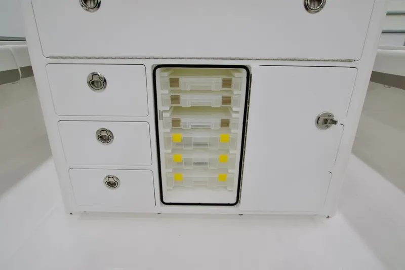 31-406 Yacht Photos Pics 2026 Regulator 31 boat storage compartment with drawers and tackle boxes.