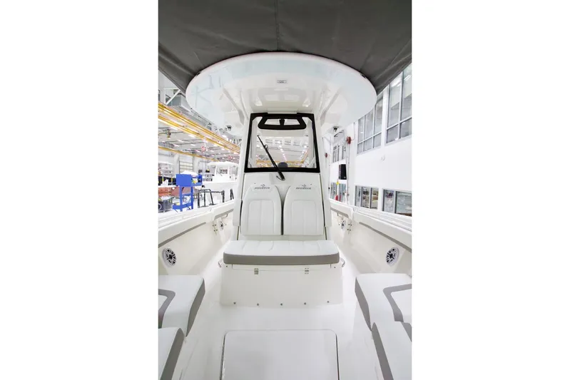 31-406 Yacht Photos Pics 2026 Regulator 31 boat interior, showcasing seating and helm in a modern factory setting.