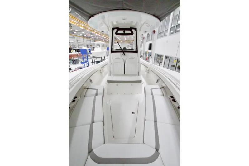 31-406 Yacht Photos Pics 2026 Regulator 31 boat interior, featuring spacious seating and modern design in a factory setting.