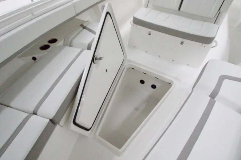 31-406 Yacht Photos Pics 2026 Regulator 31 boat interior with open storage compartment and cushioned seating.