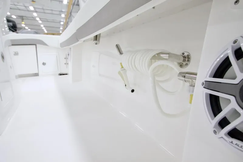 31-406 Yacht Photos Pics 2026 Regulator 31 boat interior with coiled hose and speaker in a sleek, white design.