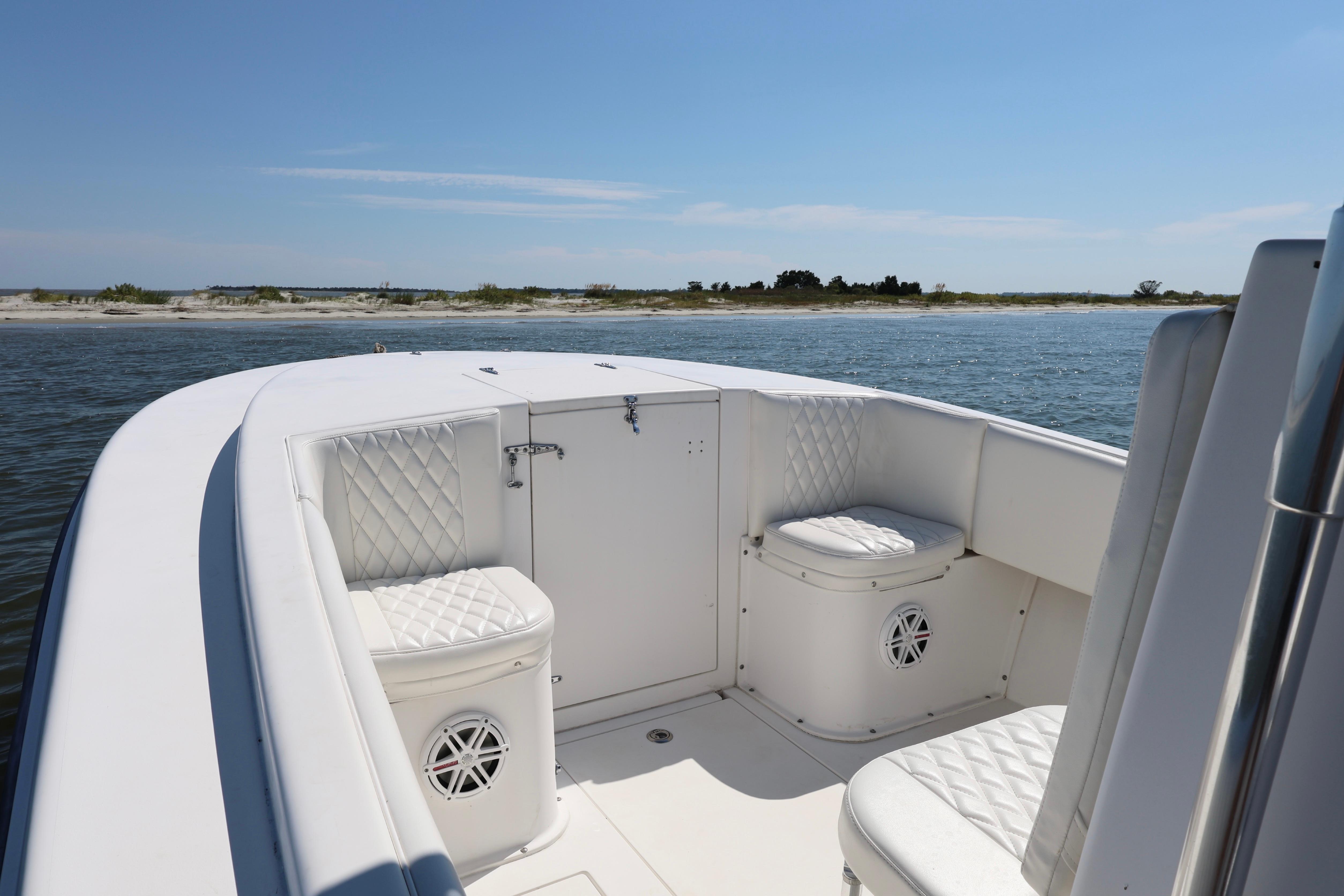 2005 Contender 31 Cuddy boat interior with white seating, on calm water.