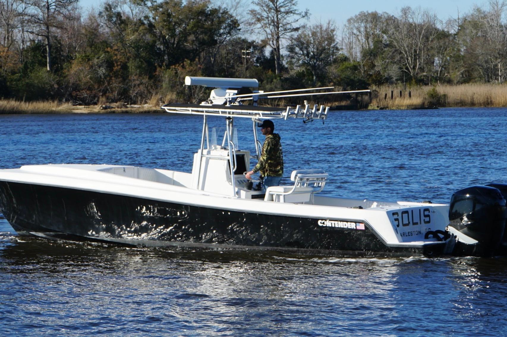 2005 Contender 31 Cuddy boat cruising on a scenic river.