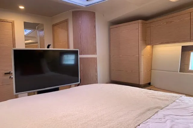  Yacht Photos Pics Luxurious interior of 2017 Hanse 588 yacht with modern furnishings and flat-screen TV.